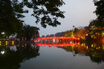 Morning time at the Huc Bridge—a wooden, red-lacquered piece of olden Vietnamese architecture that provides a spectacular view of the lake and its surroundings at Hoan Kiem Lake.