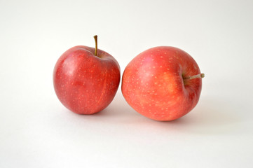 Two large appetizing red apples isolated on white background