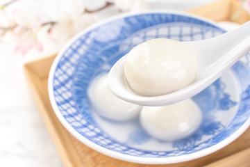 Delicious tang yuan, yuanxiao in a small bowl. Asian traditional festive food rice dumplings ball with stuffed fillings for Chinese Lantern Festival, close up.