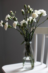  white clove/carnations bouquet in a vase