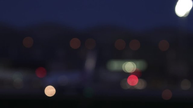 Out of focus jet plane with lights blinking in the airport at night