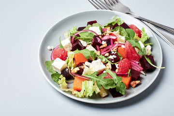 Vegetable salad with grapefruit and cheese.