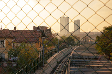 view of Istanbul from the bridge over the railway through the mesh fence into the sunset, Turkey