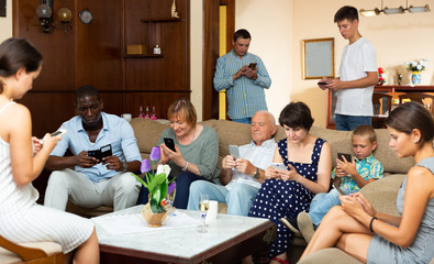 Family absorbedly looking at phones