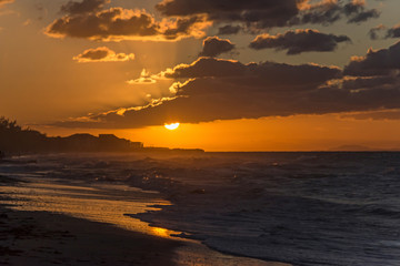 Fototapeta premium Sunset on the beach of Atlantic Ocean, Cuba