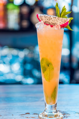 Close-up of orange alcoholic cocktail in a tall glass