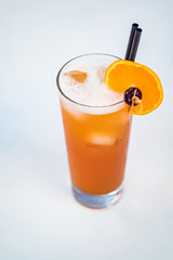 Close-up of orange alcoholic cocktail in a tall glass