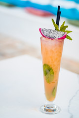 Close-up of orange alcoholic cocktail in a tall glass