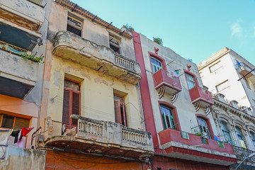 Fototapeta na wymiar Old facade of houses with balconies on the street in Havana, Cuba