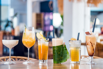 Selection of alcoholic and milkskake cocktails at bar background.