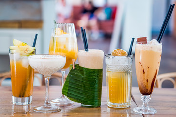 Selection of alcoholic and milkskake cocktails at bar background.