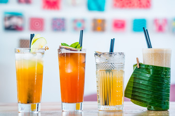 Selection of alcoholic and milkskake cocktails on a wooden table.