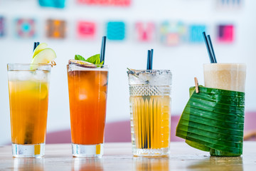 Selection of alcoholic and milkskake cocktails at bar background.