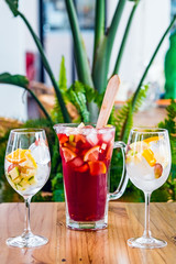 Close-up of a jar and glasses with traditional Spanish sangria drink.