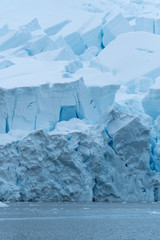 Fototapeta na wymiar Glacier wall, Paradise Harbor, also known as Paradise Bay, behind Lemaire and Bryde Islands in Antarctica.