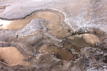 Evening light in puddles on salty shore lake Baskunchak