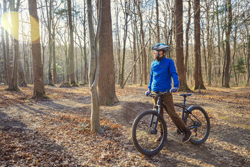 Naklejka premium Guy on his mountain bike in forest. Sport fitness motivation and inspiration outdoors