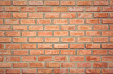 Obraz premium Old Orange brick wall concrete or stone texture background, wallpaper limestone abstract to flooring and homework/Brickwork or stonework clean grid uneven interior rock old. Copy space.