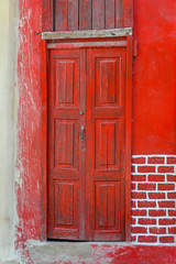Old red door of a house in Havana, Cuba