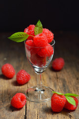 Ripe sweet raspberries in small cup