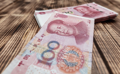 One hundred Chinese yuan on a wooden background