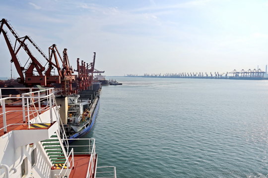 Type of cargo terminal and cranes, berths for transshipment of bulk cargo iron ore. Port Rizhao, China.