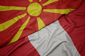waving colorful flag of peru and national flag of macedonia.