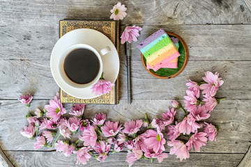 Rainbow cake with a cup of coffee 