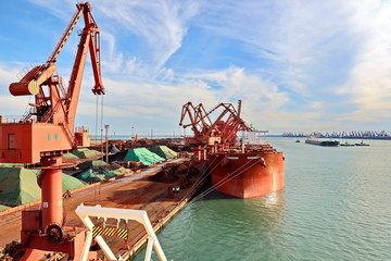 Type of cargo terminal and cranes, berths for transshipment of bulk cargo iron ore. Port Rizhao, China.