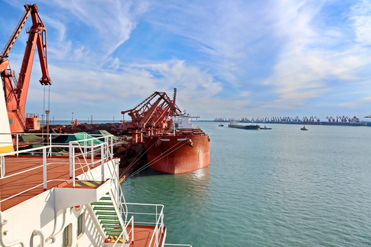 Type of cargo terminal and cranes, berths for transshipment of bulk cargo iron ore. Port Rizhao, China.