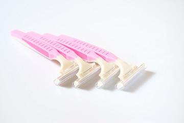 Pink razor on white background