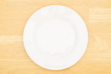 White empty plate on a wood table