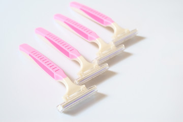 Pink razor on white background