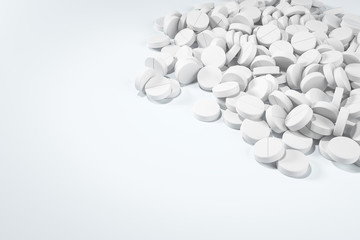 Heap of white round pills at the white table. Top view with copy space. Pharmaceutical industry and health care concept.