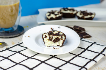 Mini homemade cheesecakes in chocolate baskets and coffee with milk for breakfast, sugar free dessert, healthy food, proper nutrition