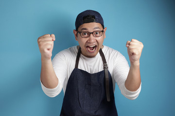 Naklejka premium Happy Proud Asian Chef or Waiter Shows Winning Gesture