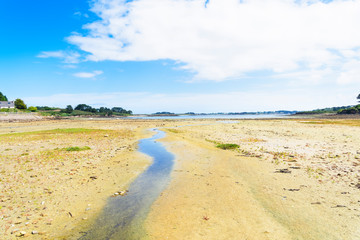 Meandering stream across Kermengi, France, harbour at low tide