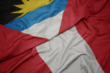 waving colorful flag of peru and national flag of antigua and barbuda.