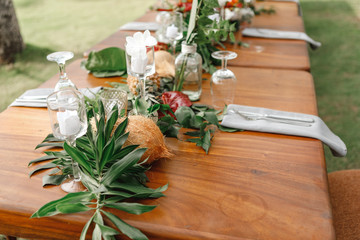Romantic Wedding Table Top for Two 2 people Layout Table Spread no people tropical beach location with gold cutlery and scenic view of sunset on the beach soft light