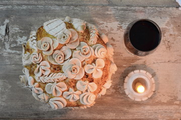 Homemade decorated Serbian slava bread with red wine.
