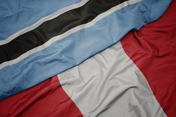 waving colorful flag of peru and national flag of botswana.