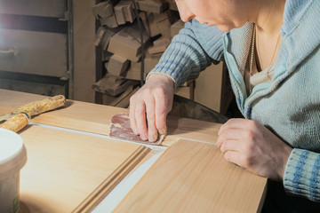 Woman joiner works in the carpentry shop
