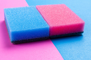 blue and pink dishwasher sponge on a coloured background