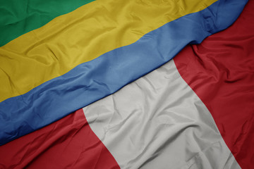 waving colorful flag of peru and national flag of gabon.
