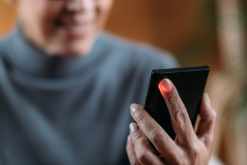 Senior Woman Measuring Pulse or Heart Rate with Smart Phone