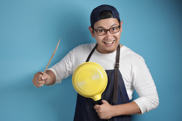 Asian Male Chef Ready to Cook, Chef Holding Kitchen Tools Spatula and Pan