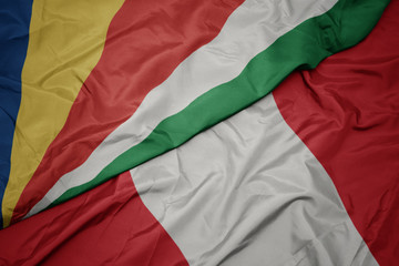 waving colorful flag of peru and national flag of seychelles.