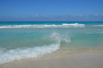 Fototapeta na wymiar The sea rushes in waves on the sandy shore. Daylight