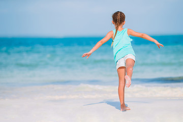 Cute little girl at beach during caribbean vacation