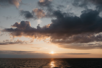 Naklejka na ściany i meble Cloudy spectacular sunset on the baltic sea